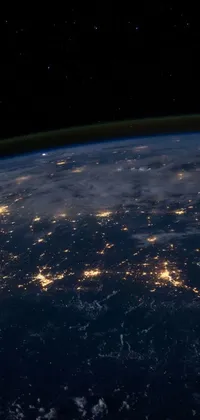 This is an awe-inspiring phone live wallpaper featuring a breathtaking view of planet earth at night as seen from space