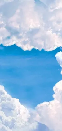 This live wallpaper for smartphones features a heart-shaped cloud floating on a blue sky background