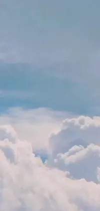 This phone live wallpaper features a jetliner soaring through mesmerizing clouds in a stunning blue sky
