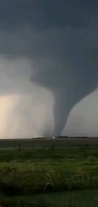 This live wallpaper showcases a tornado swirling through an open field, adding a thrilling and intense atmosphere to your phone screen