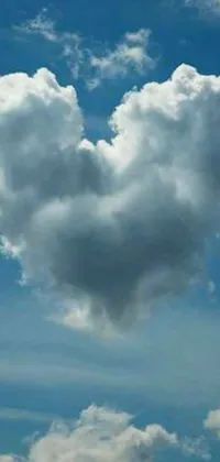This beautiful live wallpaper features a heart-shaped cloud set against a stunning blue sky