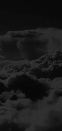 This phone live wallpaper features a captivating black and white photo of textured stormclouds with an album cover at the center