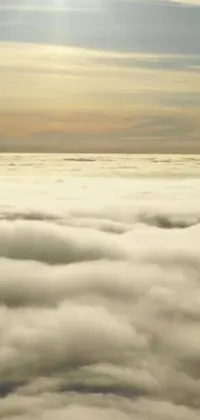 This phone live wallpaper displays a plane flying high above clouds, captured from a movie screenshot