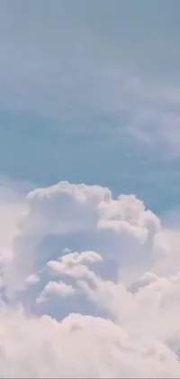This stunning live wallpaper showcases a jetliner flying through a serene blue sky, surrounded by fluffy cumulus clouds