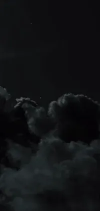 This live wallpaper features a beautiful photo of a black and white full moon set against a dark sky