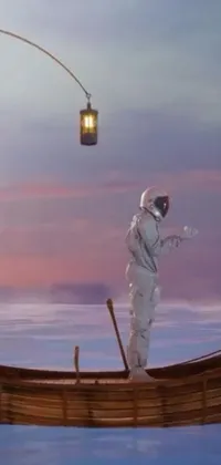 This phone live wallpaper features a surreal image of a man standing on a boat in the vast ocean