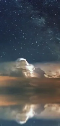 This phone live wallpaper showcases a beautiful, reflective night sky over a body of water