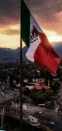 This live phone wallpaper showcases a stunning Mexican flag flying in the breeze over a bustling city
