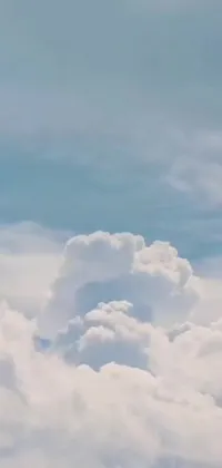 The phone live wallpaper showcases a stunning image of a jetliner flying through a serene blue sky surrounded by fluffy white clouds