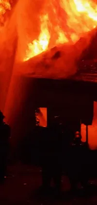 This phone live wallpaper depicts a raging house fire at night with stunning dramatic lighting