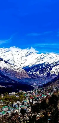This live wallpaper showcases the scenic beauty of a town nestled amidst majestic snowy mountains