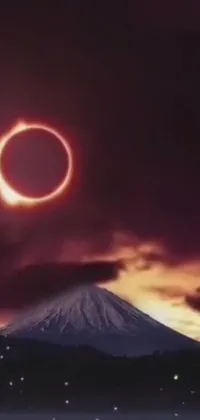 This phone live wallpaper depicts a stunning solar eclipse over a mountain landscape, rendered in a surrealistic style