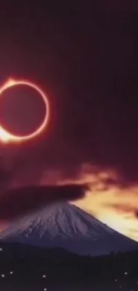 This phone live wallpaper showcases a stunning mountain amidst a fiery sky, featuring a ring of fire and an eclipse
