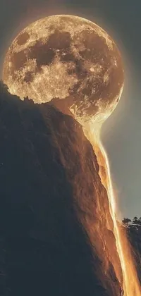 This live wallpaper depicts a man gazing out over a gorgeous mountain landscape beneath a full moon
