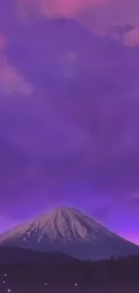 This stunning phone live wallpaper showcases a beautiful purple and pink sky with a magnificent mountain in the background