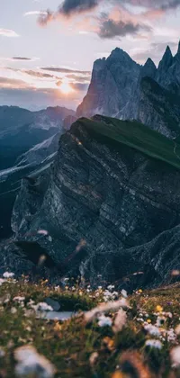 This phone live wallpaper captures a breathtaking sunset scene on top of a magnificent mountain