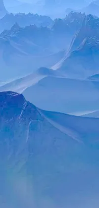 If you're a nature and aviation enthusiast, don't miss out on this mesmerising phone live wallpaper! The artwork showcases an aerial view of snow-capped mountains, valleys, and dunes with a majestic plane soaring above