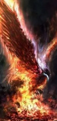 This phone live wallpaper features a mesmerizing scene of a bird with flaming wings soaring through the air over a burning fire pit