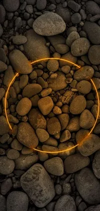 This stunning phone live wallpaper features a captivating circle of rocks, digital art, glowing amber hues, lava rock, and a dry river bed