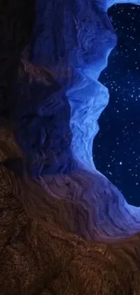 This impressive live wallpaper depicts a stunning view of the night sky from the interior of a cave
