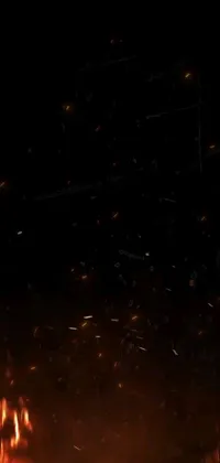 Enjoy the mesmerizing and captivating phone live wallpaper featuring a swarm of fluttering fireflies surrounding a vibrant fire in the dark
