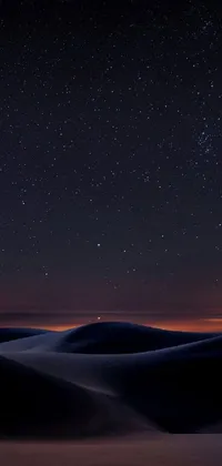 Enjoy a mesmerizing view of the desert at night with stars in the sky, captured in this beautiful phone live wallpaper