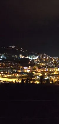 Get a stunning and lively live wallpaper of a city at night on your phone! This close-up view from a hill in Turkey depicts a breathtaking cityscape where colorful lights dot the dark sky like stars