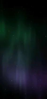This live wallpaper for your phone features a breathtaking display of a green and purple aurora borealis in the night sky