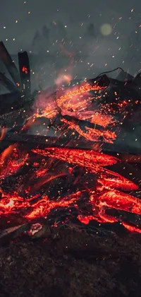 This live wallpaper features a mesmerizing close up of a rising blaze emitting golden sparks