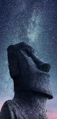 This phone live wallpaper depicts a close-up of a surreal statue against a backdrop of a night sky full of stars