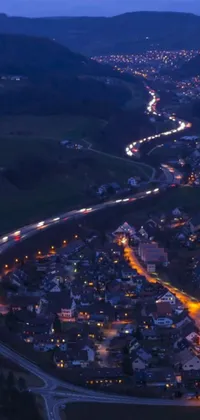Looking for a stunning live wallpaper for your phone? Check out this aerial view of a city at night, showing highways and a village nearby