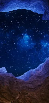Transform your phone into a stunning desert cave with a captivating live wallpaper featuring a star-filled sky
