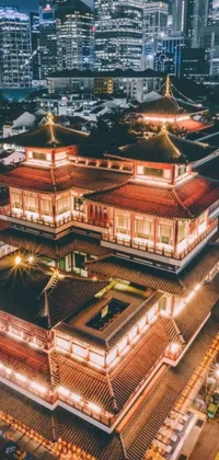 This phone live wallpaper features a colorful aerial view of a city at night with a Chinese temple and Tibetan-inspired architecture