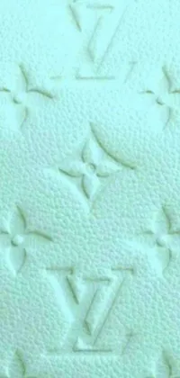 This phone live wallpaper features an aesthetically pleasing close-up of a white Louis Vuitton bag with an embossed aquamarine paint