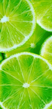 This stunning phone live wallpaper features a close up of lime slices arranged in a circular pattern against an abstract green and yellow background, which creates a mesmerizing and dynamic effect as the slices rotate around the screen