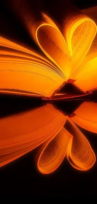 Decorate your phone's screen with a mesmerizing live wallpaper featuring a candle and an open book