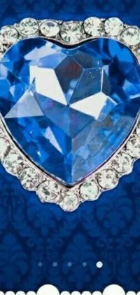 This live wallpaper features a stunning heart-shaped diamond centerpiece set against a calming blue background, perfect for adding a touch of regal elegance to any mobile phone device