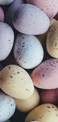 Looking for a playful and whimsical live wallpaper for your phone? Look no further than this adorable design featuring speckled eggs piled on top of each other