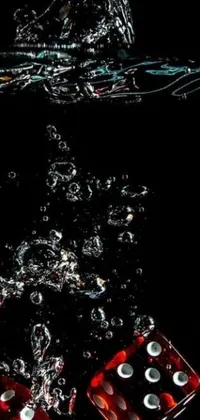 Bring your phone screen to life with this stunning live wallpaper featuring a pair of dice falling into water