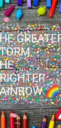 This stunning and inspirational phone live wallpaper features a vibrant crayon art design with a powerful message that reads "the greater storm is the brighter rainbow"