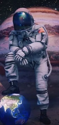 This phone wallpaper showcases a hyperrealistic digital art design of an astronaut crouching next to Earth in a spacesuit