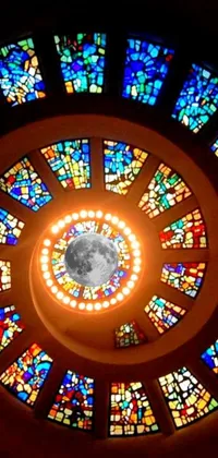 This phone live wallpaper portrays a circular stained glass window mosaic in a church