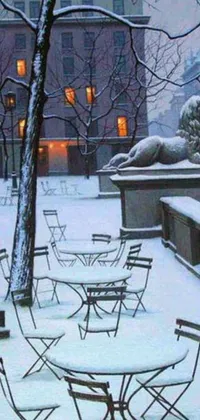 This phone live wallpaper depicts a serene winter cityscape with empty chairs resting on a snow-covered ground