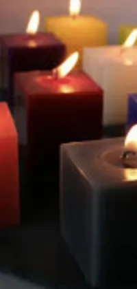 Experience the calming and inviting ambiance of a group of candles with this phone live wallpaper