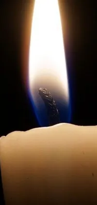 Bring warm, cozy vibes onto your phone screen with this mesmerizing candle flame live wallpaper