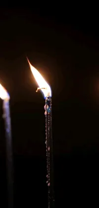 This live wallpaper features a group of candles with flickering flames, adding a cozy and warm ambiance to your phone screen