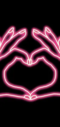 This phone live wallpaper features a heart-shaped formation of two hands in neon pink, inspired by a digital rendering