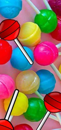 Looking for a fun and playful live wallpaper for your phone? Look no further than this colorful image featuring a bunch of lollipops sitting on top of each other
