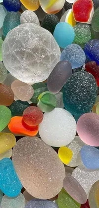 This dynamic live wallpaper features a delightful pile of sea glass sitting atop a table