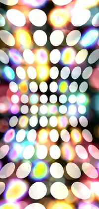 This lively live wallpaper features an abstract bokeh pattern of differently-sized circles set against a black background